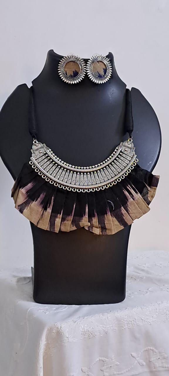 Exclusive necklace with silver oxidised big oval pendant with fabric fringes and matching earrings.