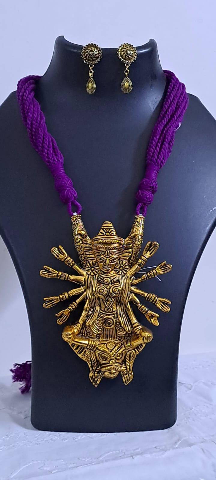 Purple thread necklace with oxidised golden durga pendant