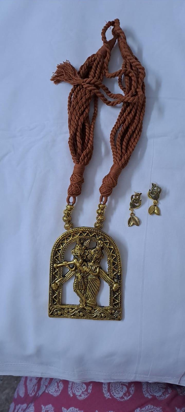Radha Krishna golden oxidised pendant necklace in brown tread with matching earrings