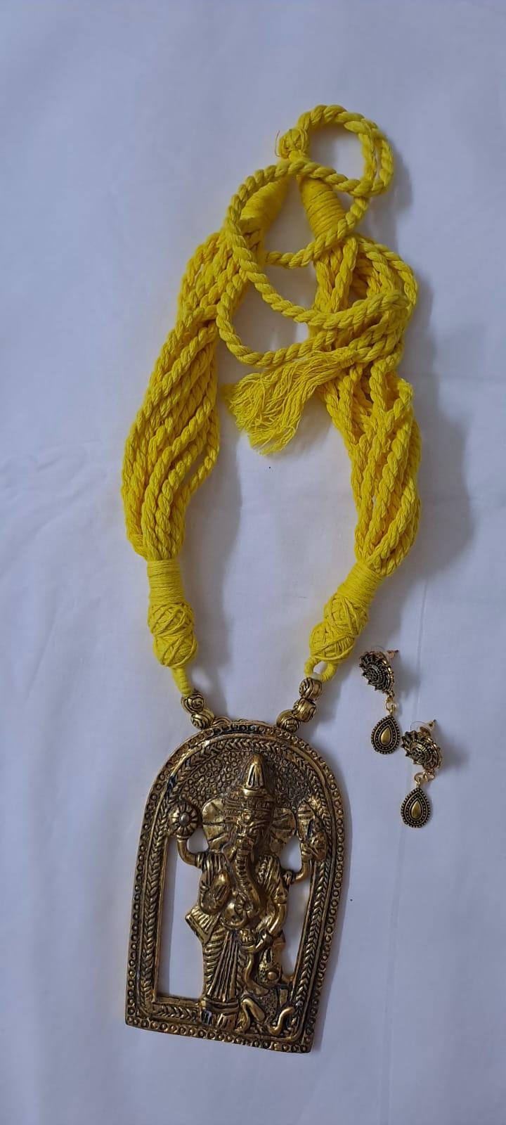 Yellow thread necklace with golden oxidised ganesha pendant