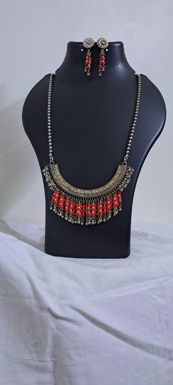 Exclusive necklace with silver oxidised big oval pendant with glass beads fringes and matching earrings.