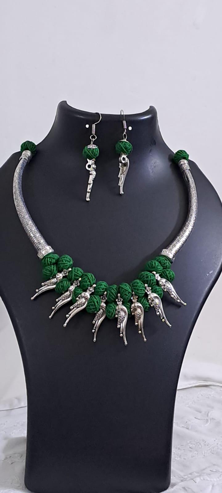 Green thread necklace with kolhapuri silver oxidised traditional beads and matching earrings