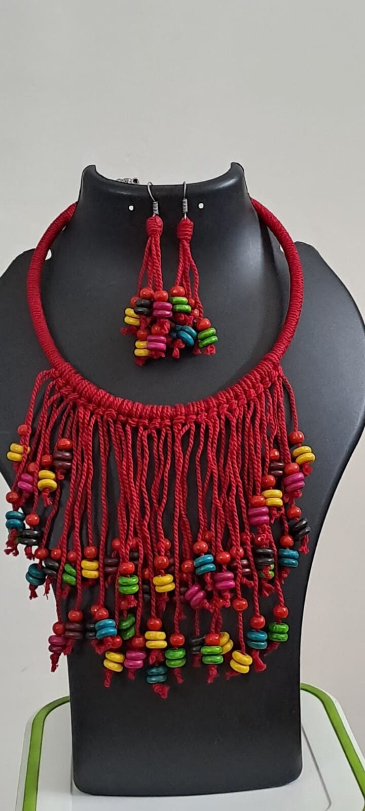 Exclusive red thread neckband with fringes and matching earrings.