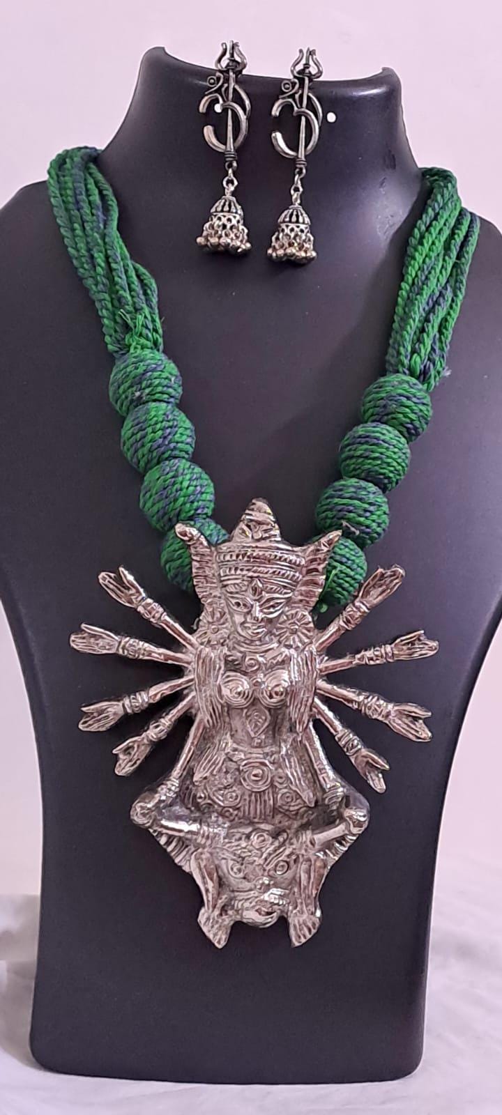 Green thread necklace with oxidised golden durga pendant