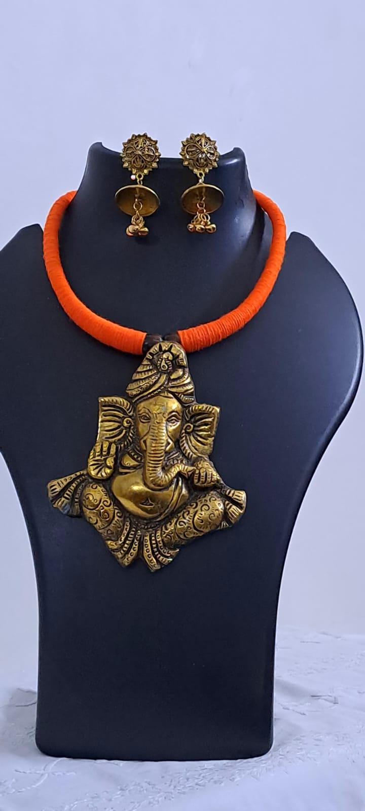 Orange thread necklace with golden oxidised ganesha pendant