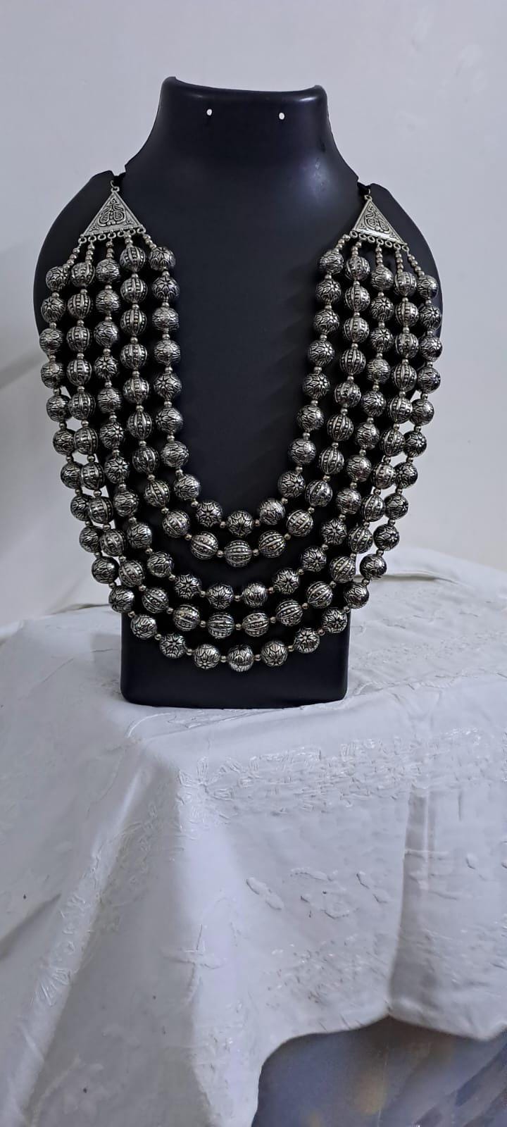 Multi-layered silver oxidised beads necklace .