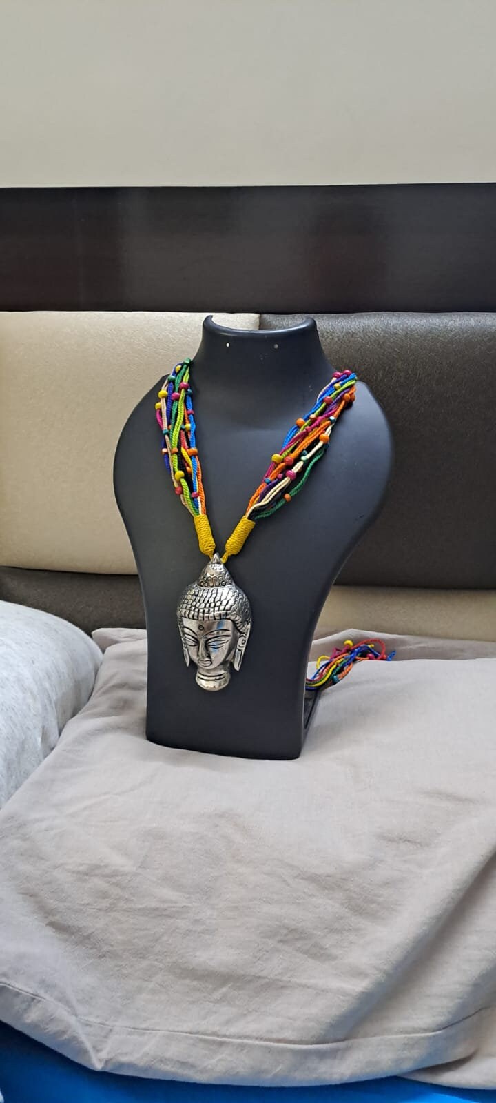 Multi coloured thread necklace with oxidised silver buddha pendant