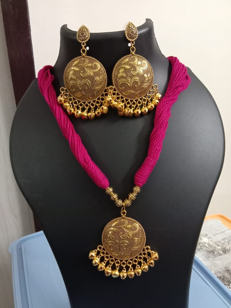 Red thread necklace with golden oxidised traditional pendant