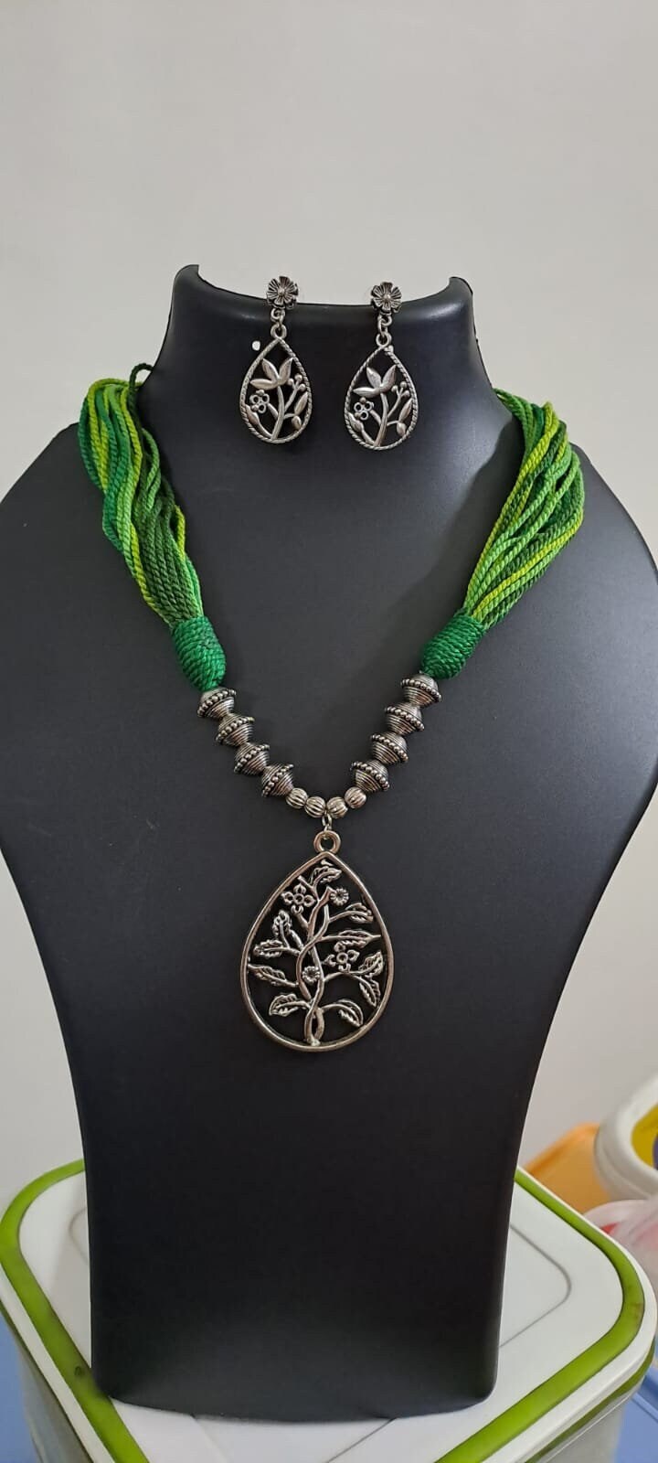 Green thread necklace with silver oxidised traditional pendant