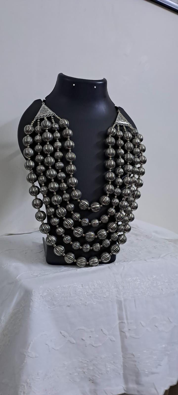 Multi-layered silver oxidised beads necklace .