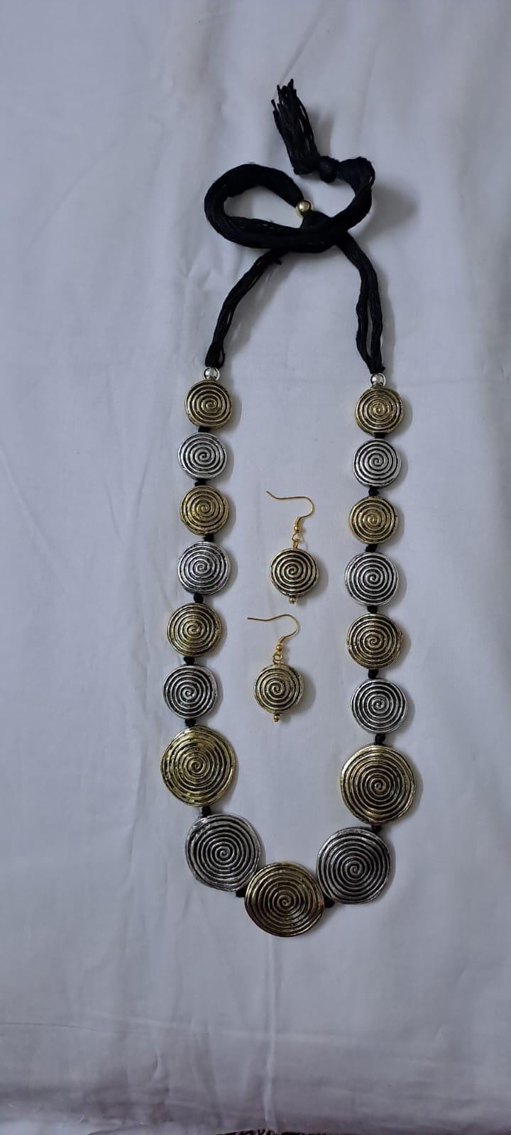Exclusive silver oxidised set with flat round beads of gold n silver tone mix n matching earrings