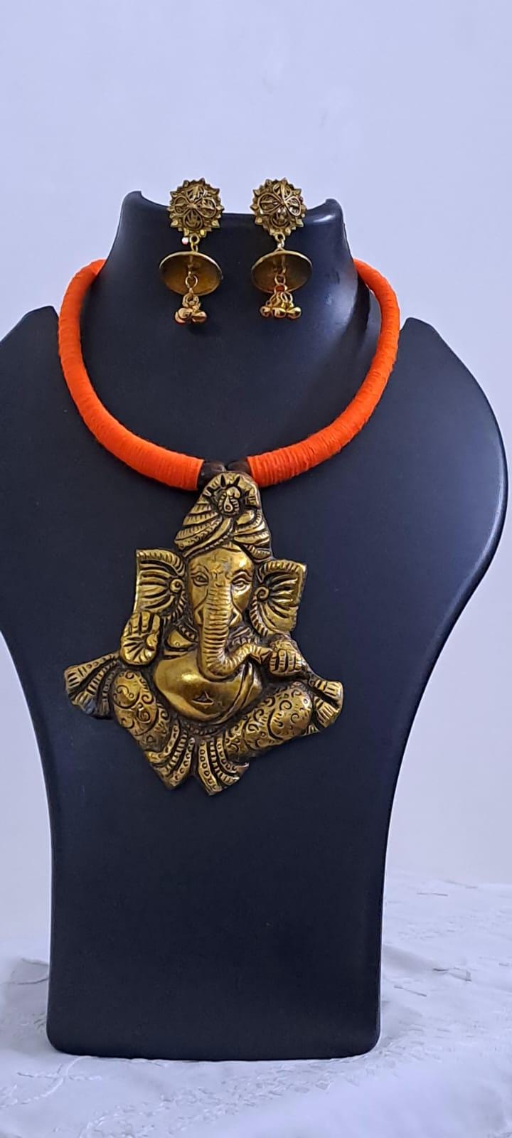 Orange thread necklace with golden oxidised ganesha pendant