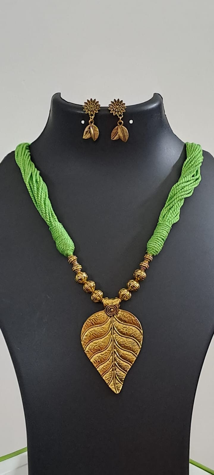 Green thread necklace with golden oxidised golden leaf traditional pendant