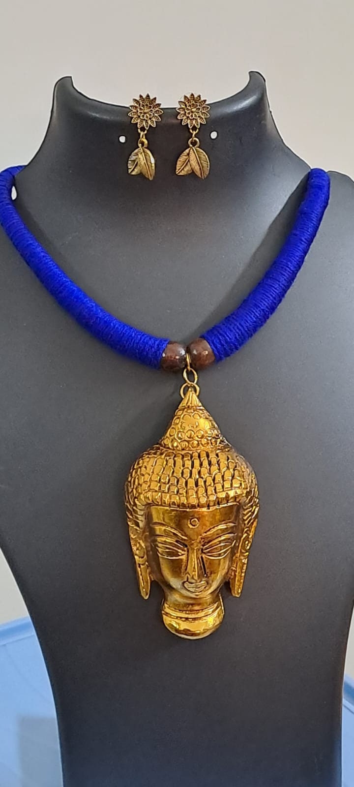 Blue thread necklace with golden oxidised buddha pendant