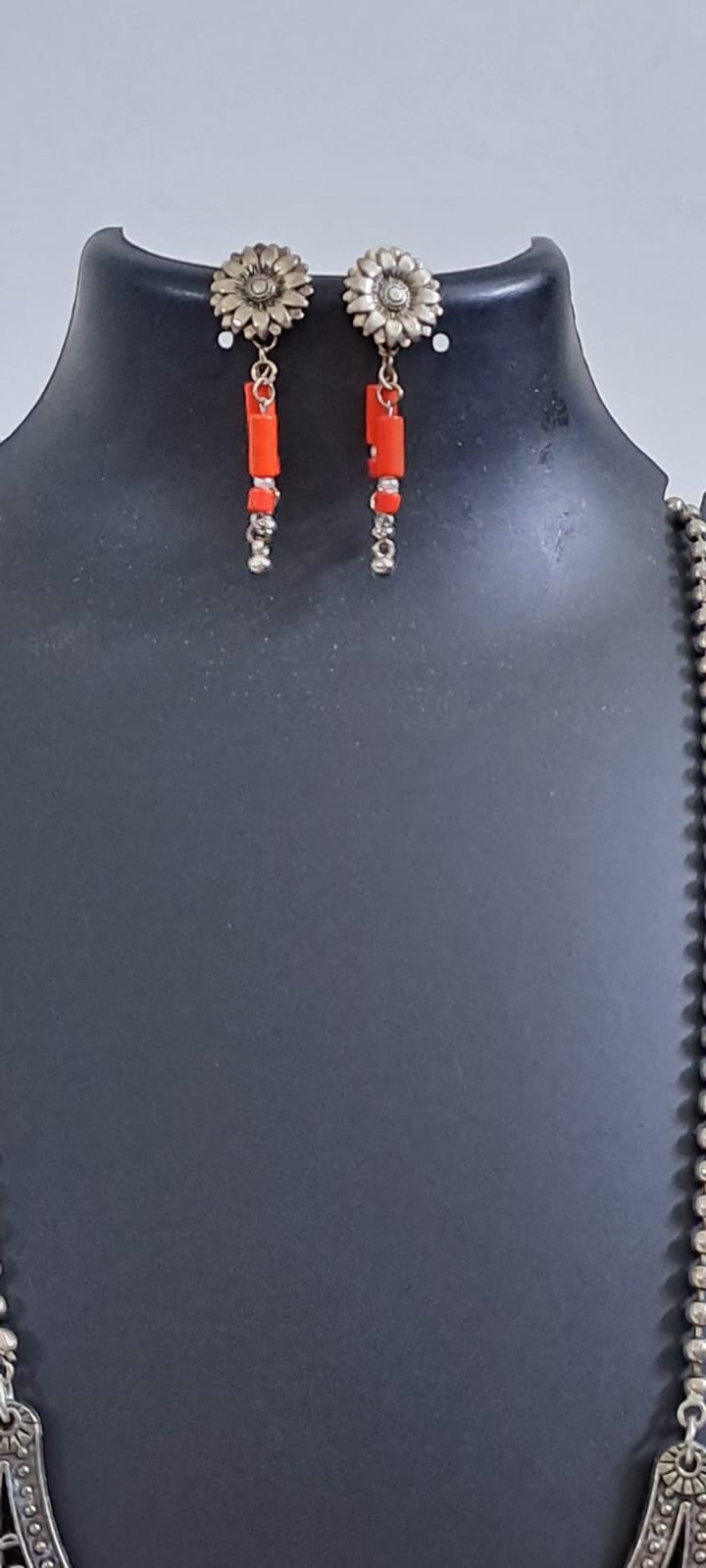 Exclusive necklace with silver oxidised big oval pendant with glass beads fringes and matching earrings.
