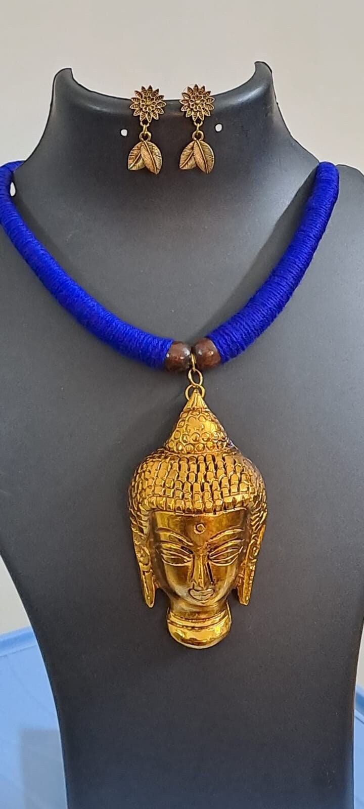 Blue thread necklace with golden oxidised buddha pendant