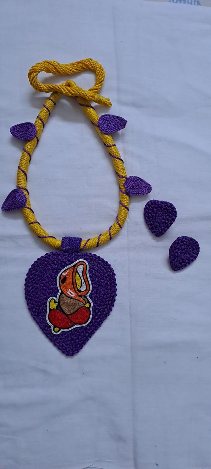 Exclusive yellow and purple thread necklace with leaf shaped  Ganesha thread pendant and matching earrings.
