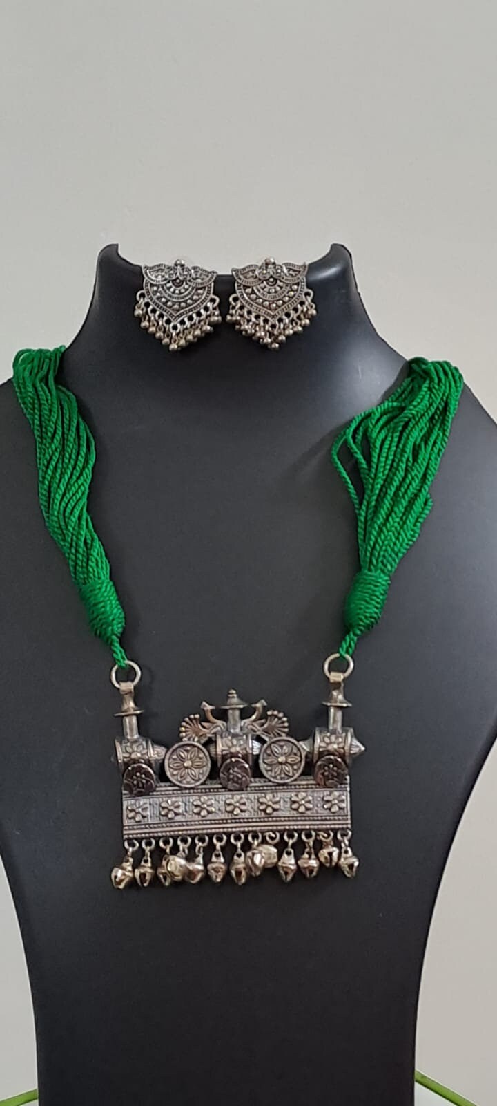 Green thread necklace with silver oxidised traditional pendant