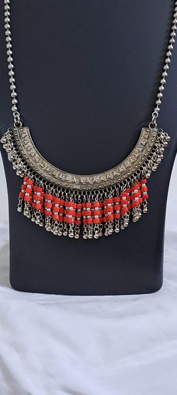 Exclusive necklace with silver oxidised big oval pendant with glass beads fringes and matching earrings.