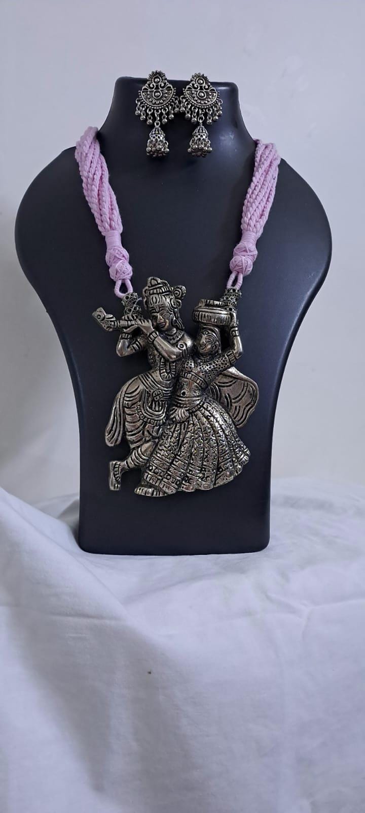 Radha Krishna silver oxidised pendant necklace in pink thread with matching earrings