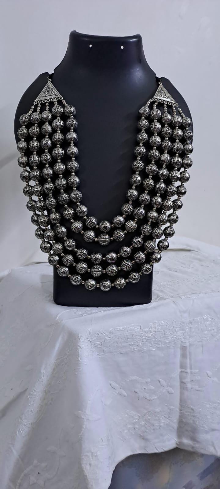 Multi-layered silver oxidised beads necklace .