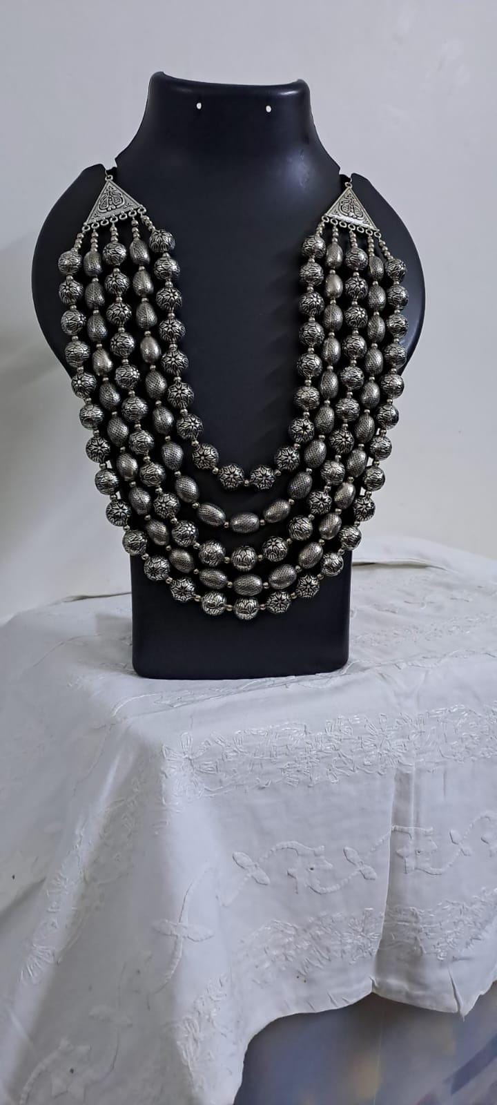 Multi-layered silver oxidised beads necklace .