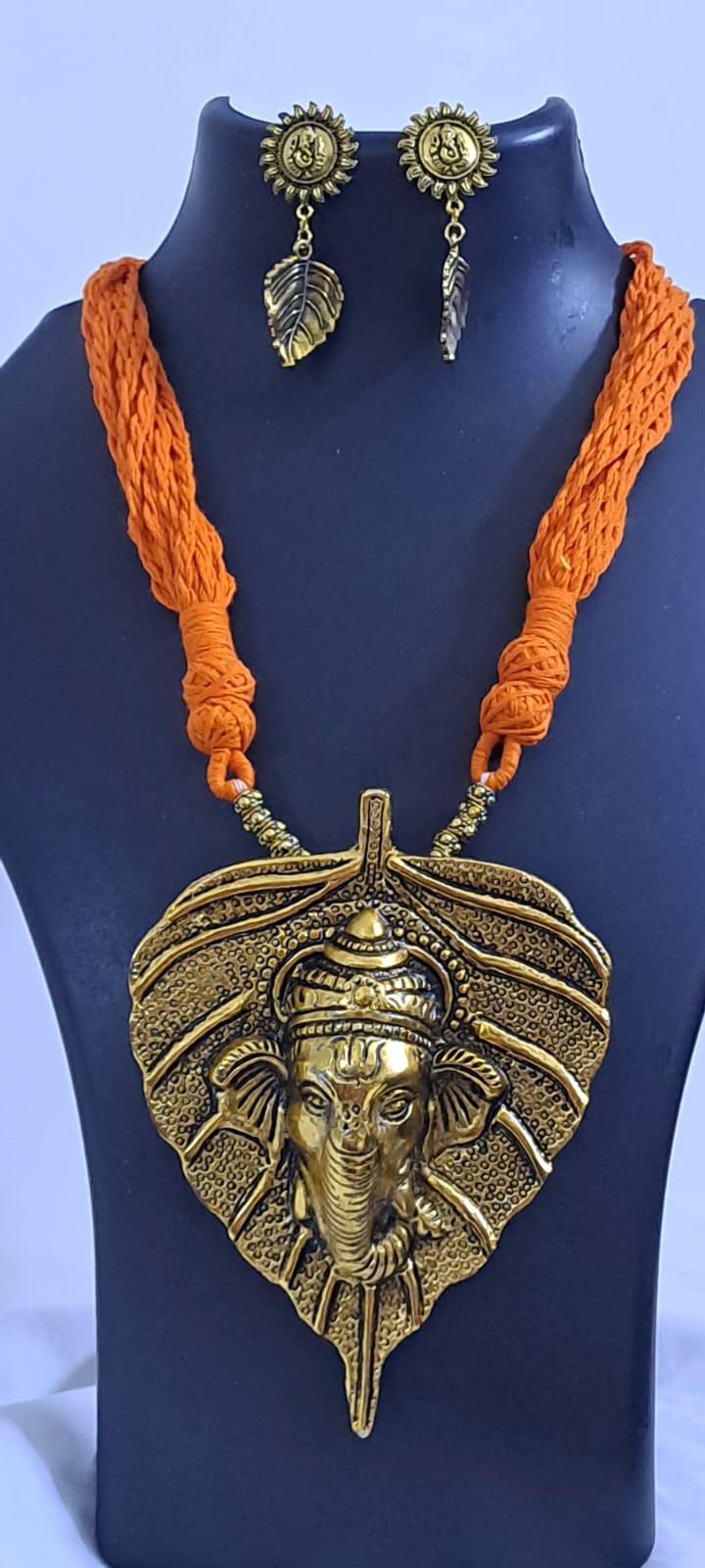 Orange thread necklace with golden oxidised ganesha pendant