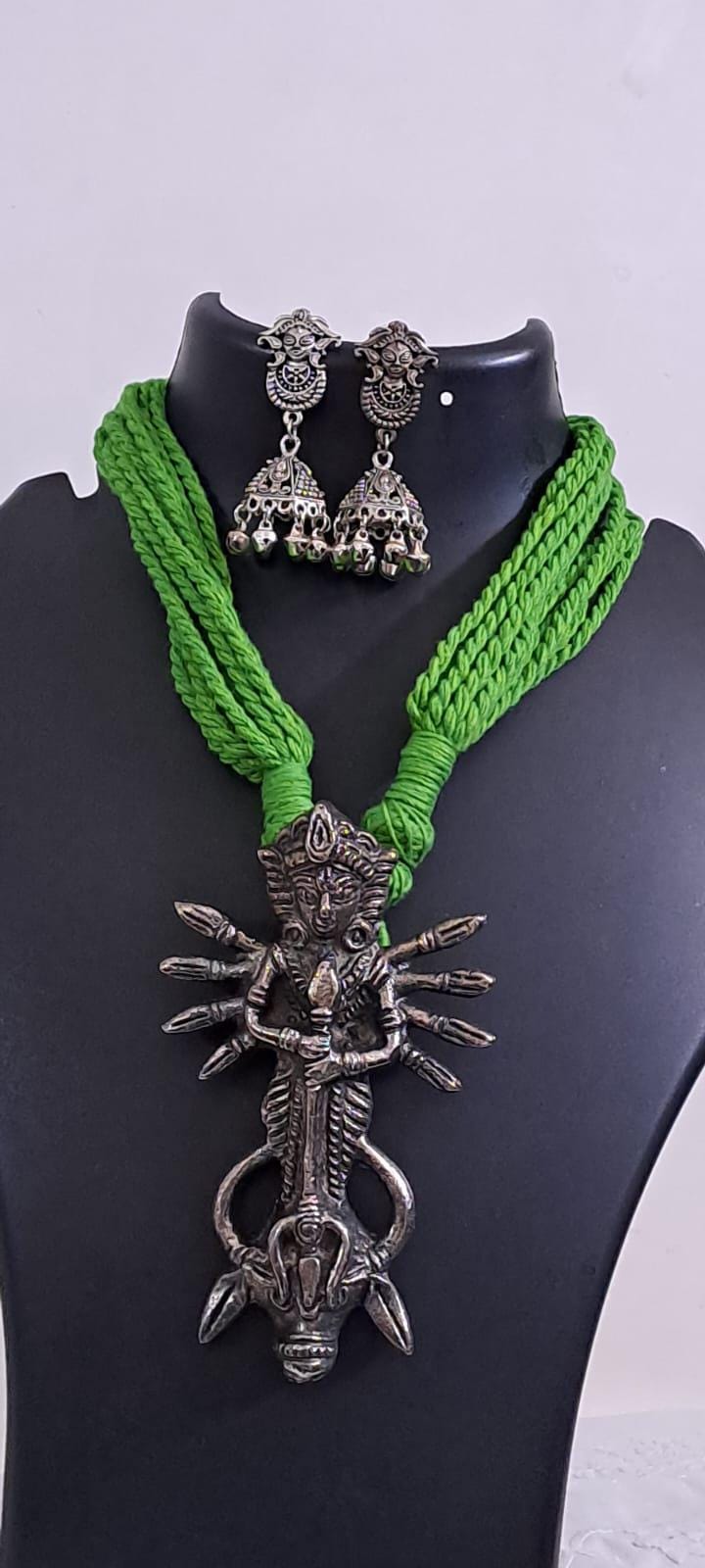Green thread necklace with oxidised silver durga pendant