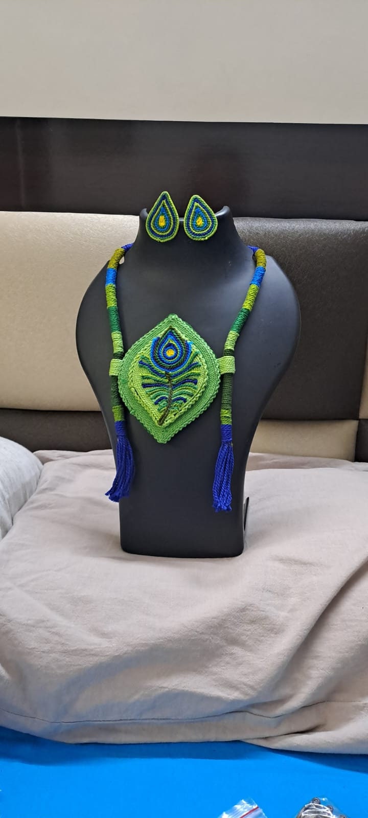 Thread necklace depicting peacock feather with shades of green. Exclusively for Janmashtami
