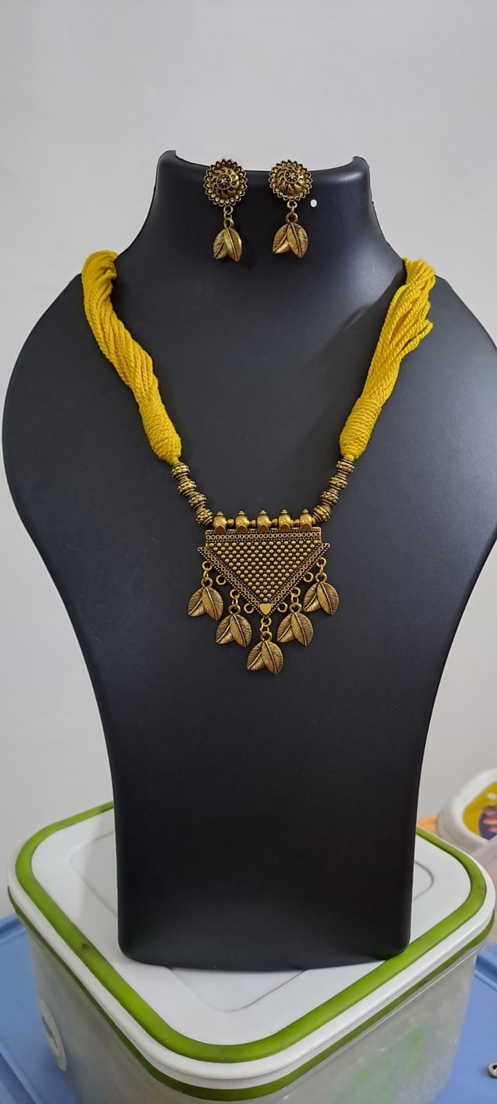 Yellow thread necklace with golden oxidised traditional pendant