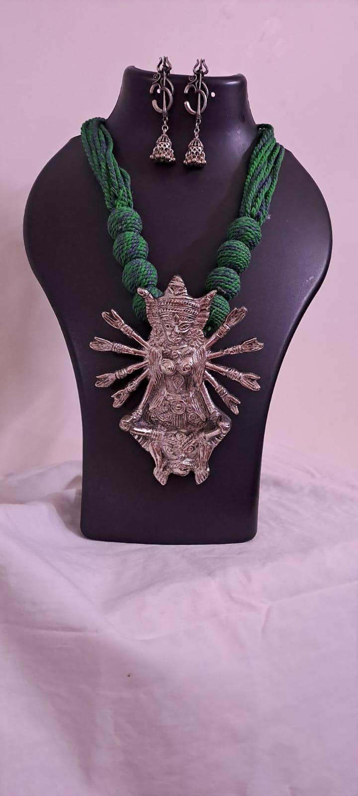 Green thread necklace with oxidised golden durga pendant
