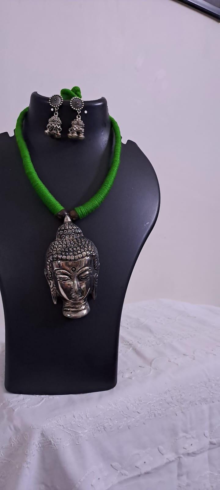 Green thread necklace with silver oxidised buddha pendant