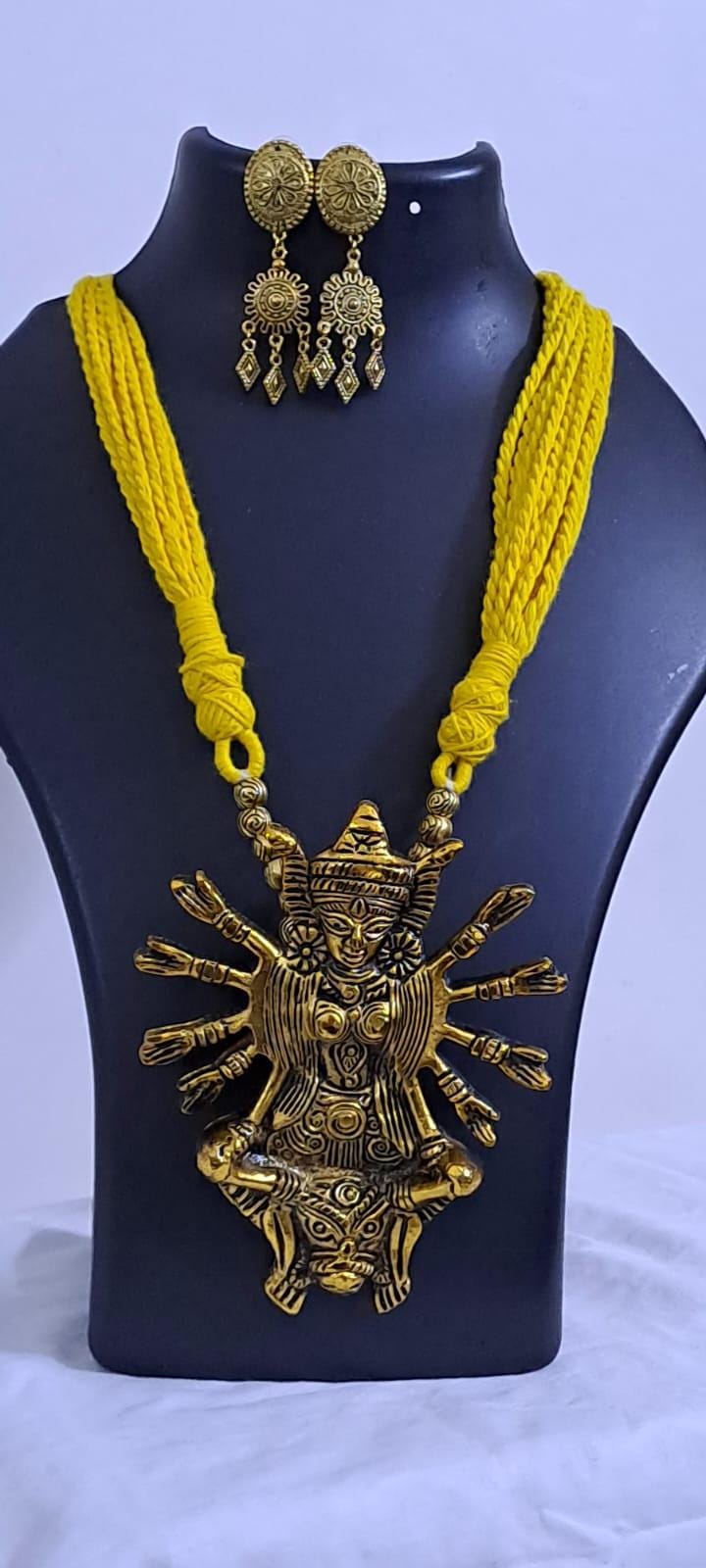 Yellow thread necklace with oxidised golden durga pendant
