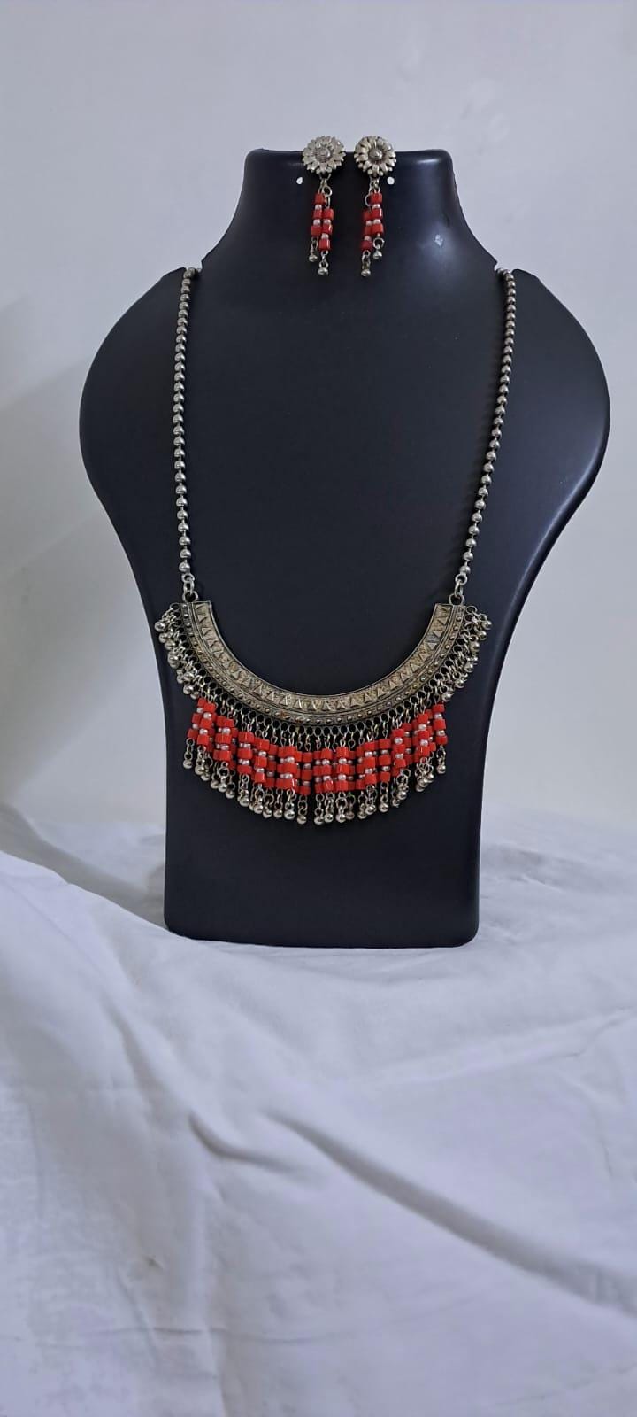 Exclusive necklace with silver oxidised big oval pendant with glass beads fringes and matching earrings.