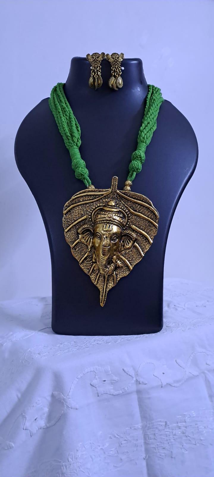 Green thread necklace with golden oxidised ganesha pendant