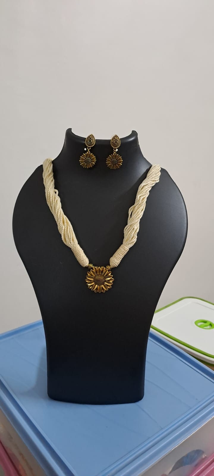 Off white thread necklace with oxidised silver sunflower pendant
