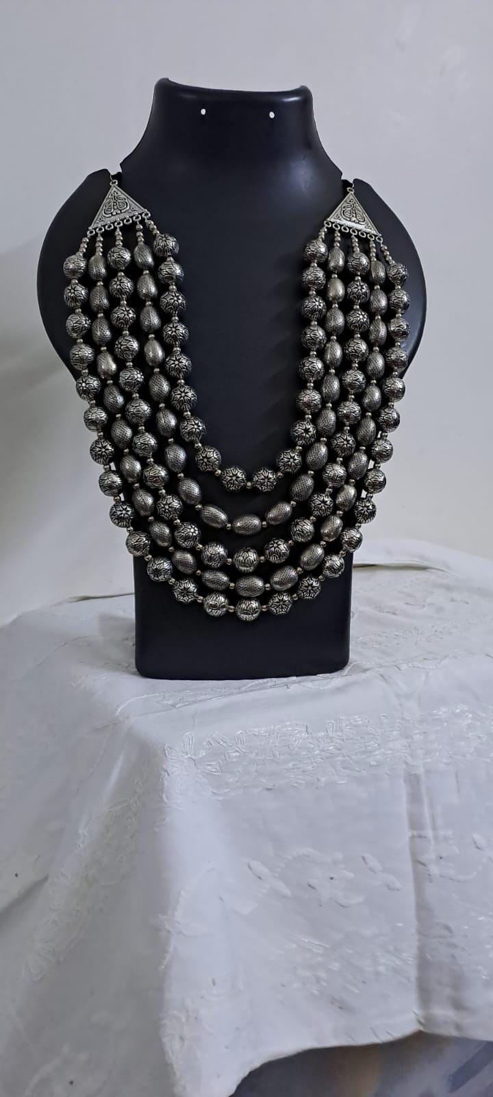 Multi-layered silver oxidised beads necklace .