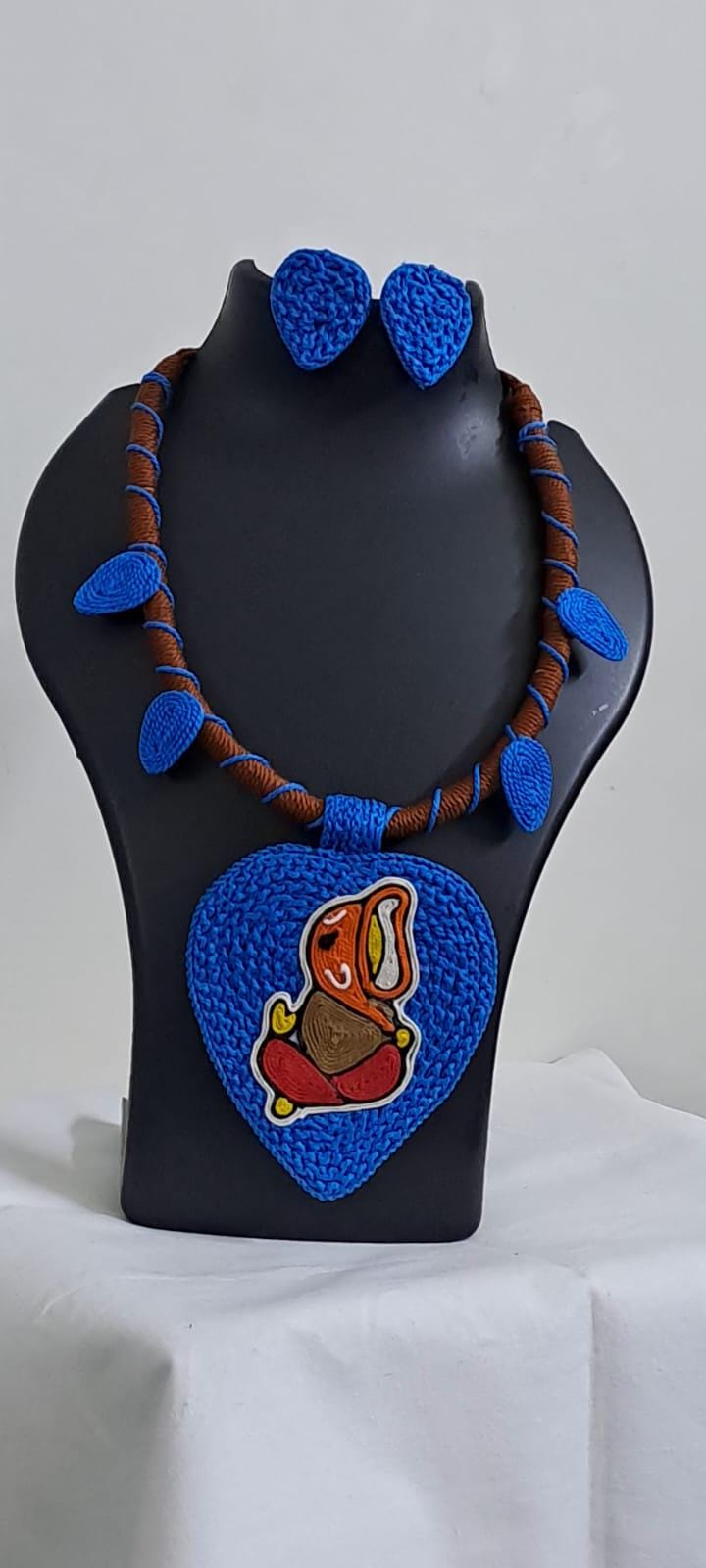 Exclusive brown and blue thread necklace with leaf shaped  Ganesha thread pendant and matching earrings.
