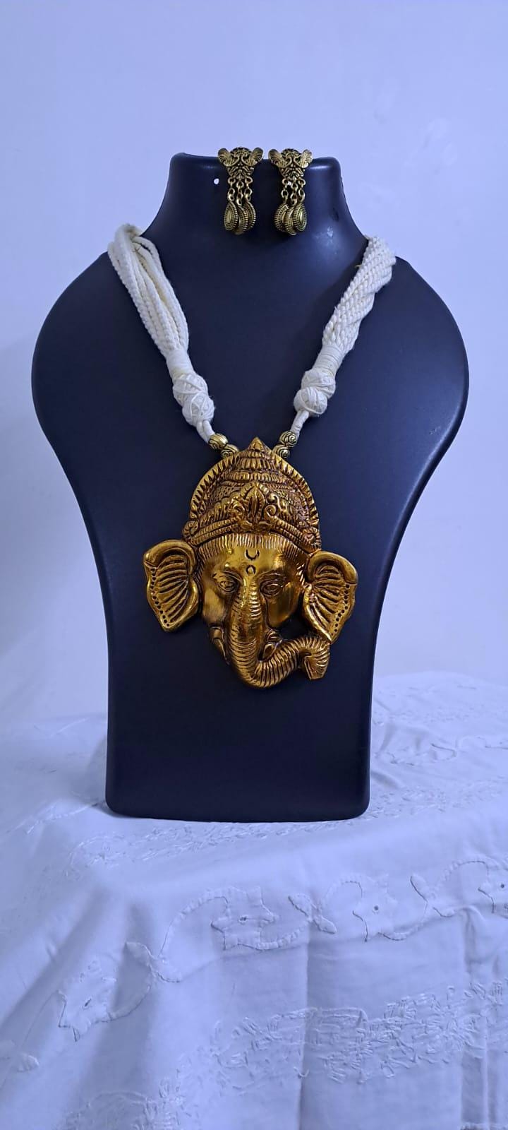 Off-white thread necklace with golden oxidised ganesha pendant