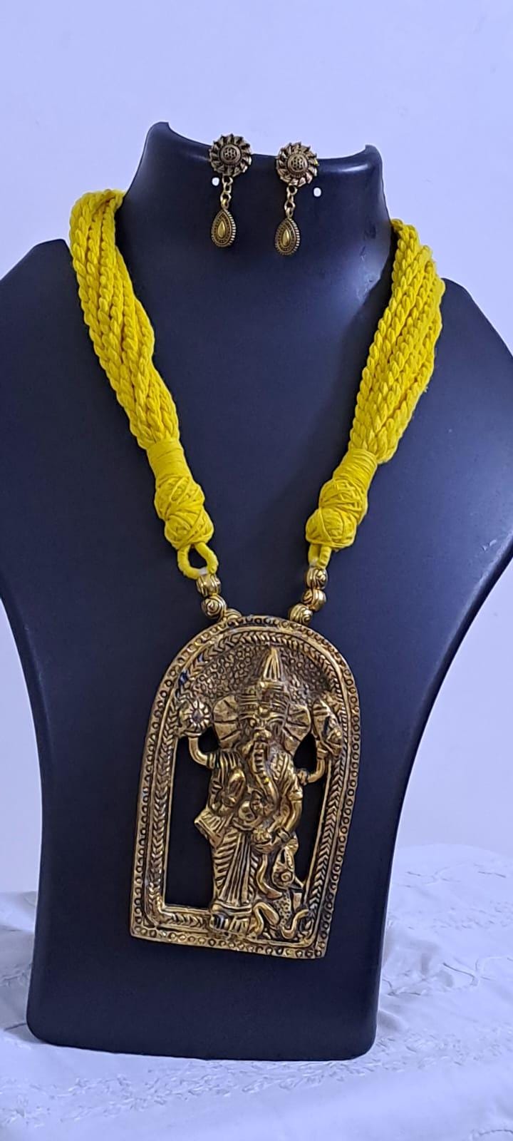 Yellow thread necklace with golden oxidised ganesha pendant