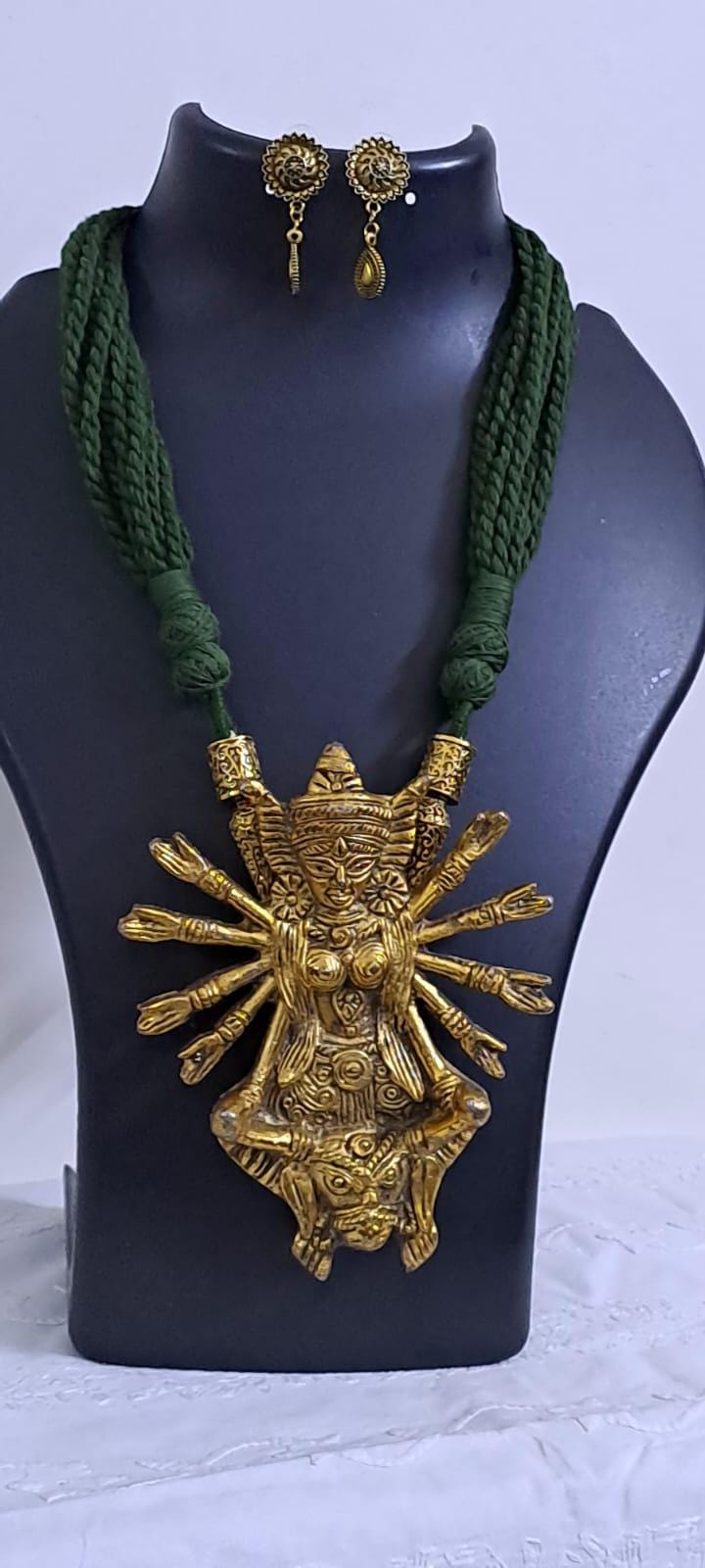 Green thread necklace with oxidised golden durga pendant