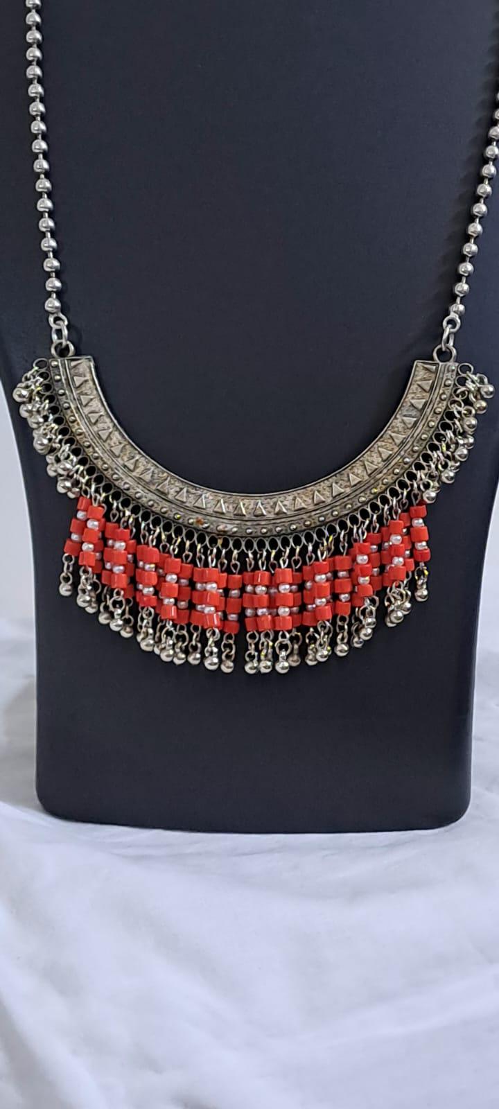 Exclusive necklace with silver oxidised big oval pendant with glass beads fringes and matching earrings.