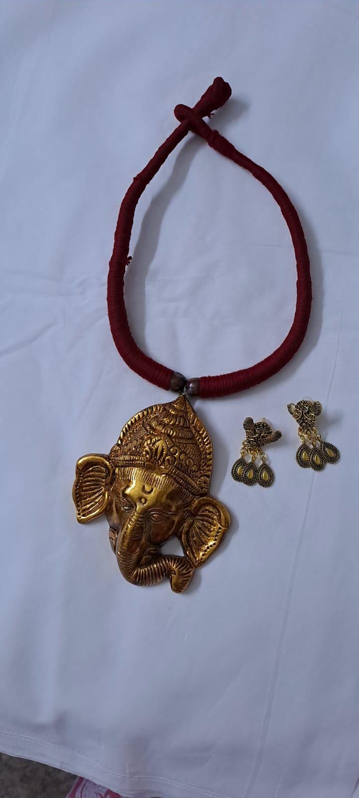 Maroon thread necklace with golden oxidised ganesha pendant