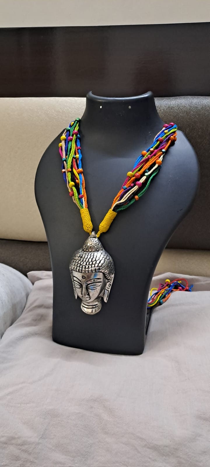 Multi coloured thread necklace with oxidised silver buddha pendant