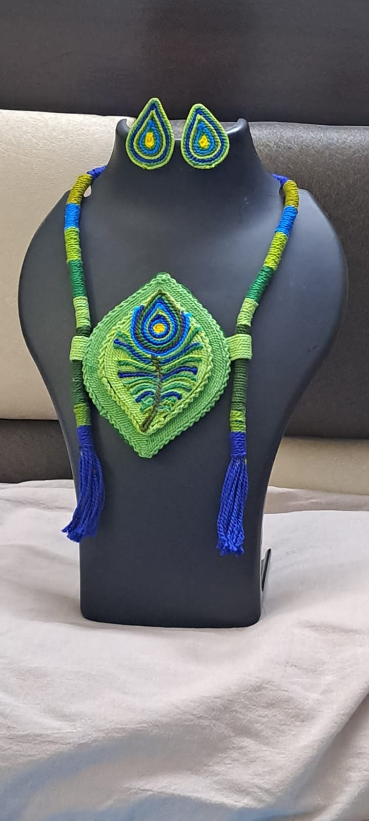 Thread necklace depicting peacock feather with shades of green. Exclusively for Janmashtami