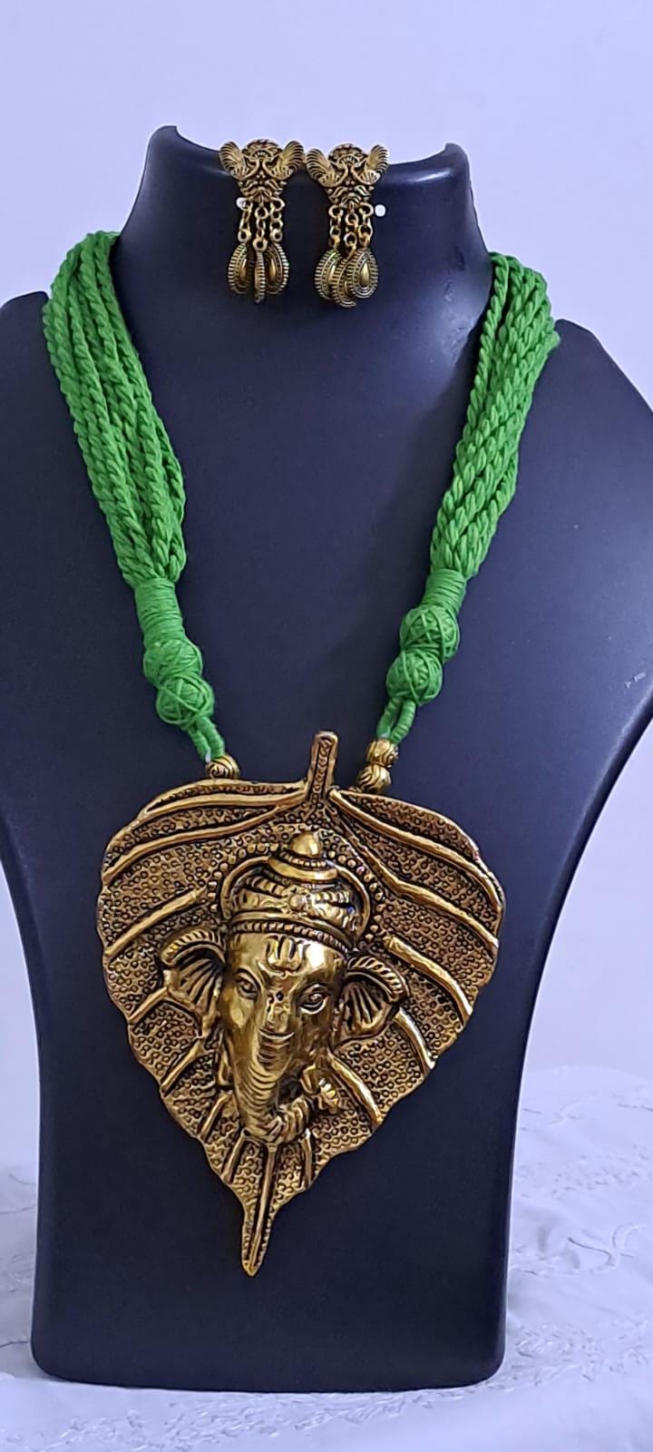 Green thread necklace with golden oxidised ganesha pendant