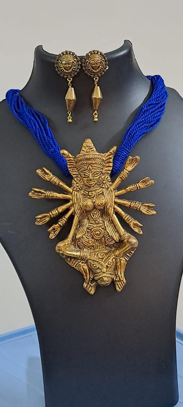 Blue thread necklace with oxidised golden durga pendant