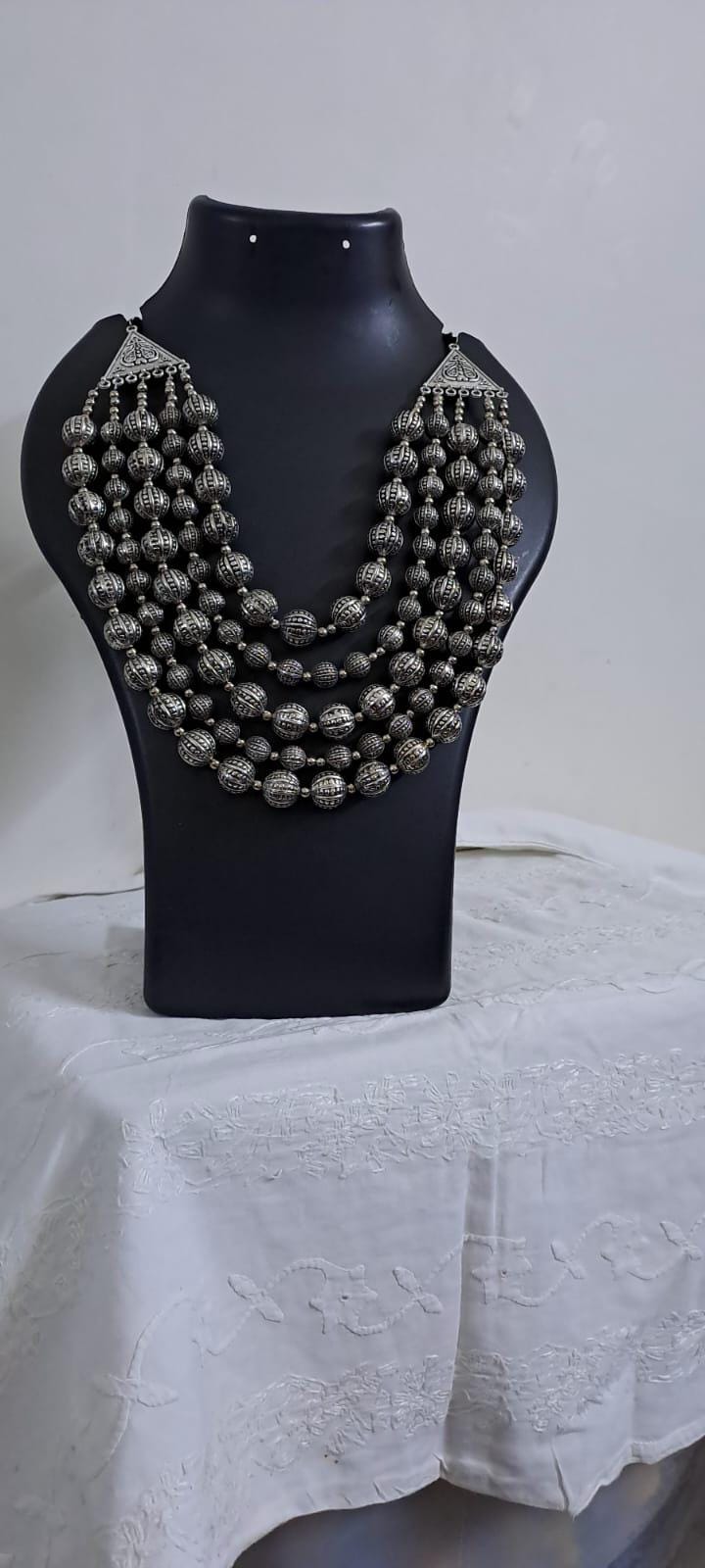 Multi-layered silver oxidised beads necklace .