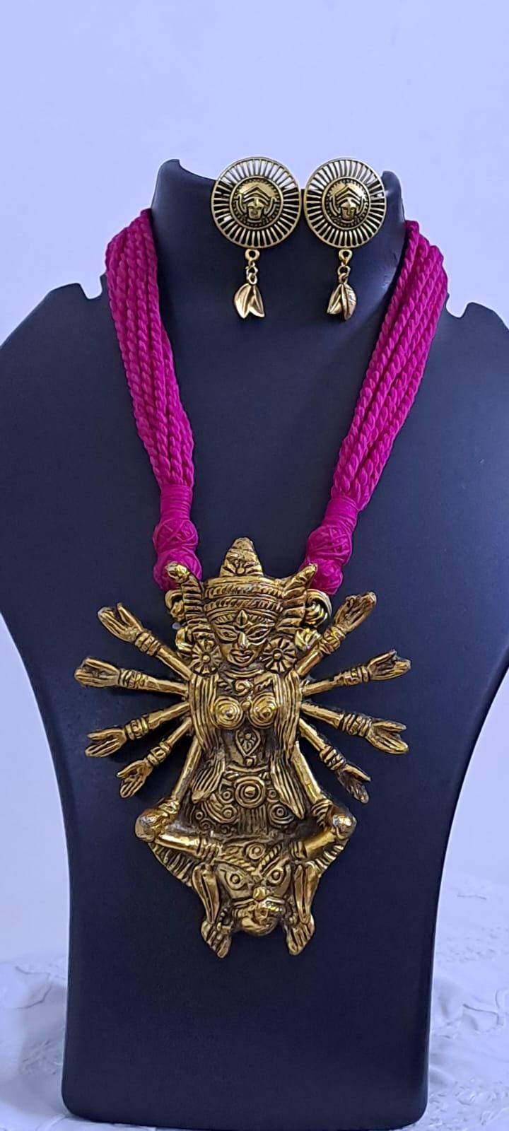 Pink thread necklace with oxidised golden durga pendant