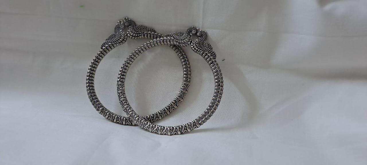 Traditional silver oxidised bangles with peacock